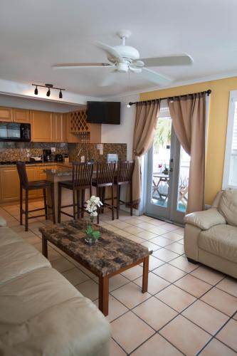 a living room with a couch and a table at Courtney's Place Historic Cottages & Inns in Key West