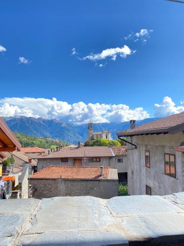 a group of buildings with mountains in the background at Casa nel centro storico di Borno in Borno