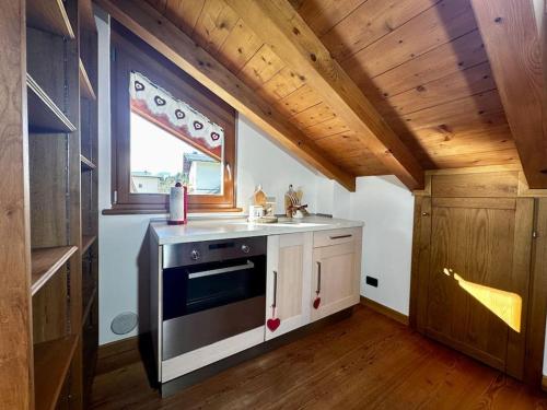 a kitchen with a sink and a window in a house at Villa Argentina dimora nelle Dolomiti in Calalzo