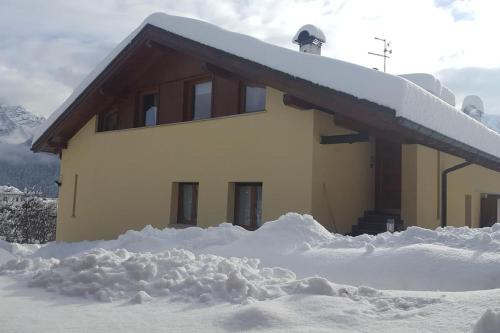 a house covered in snow with snow around it at Villa Argentina dimora nelle Dolomiti in Calalzo