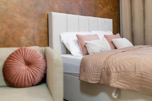 a bedroom with a bed with pillows on it at Terrace View Apartment - Golden Apartments Rezidence Nová Karolina in Moravská Ostrava