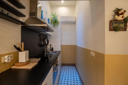a bathroom with a sink and a blue tile floor at De Moriaan Historic Center in Antwerp