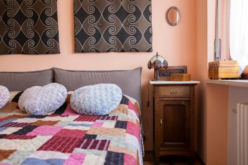a bedroom with a bed with two pillows on it at Villa La Sosta a Giaveno in Giaveno