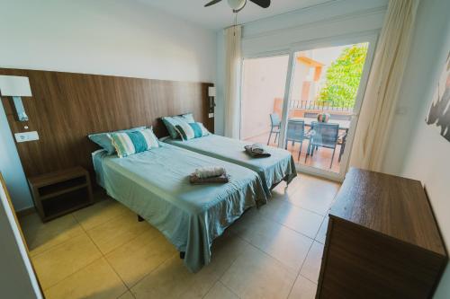 a bedroom with a bed and a view of a balcony at Bonsai in Murcia