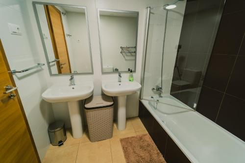 a bathroom with two sinks and a shower and a tub at Bonsai in Murcia