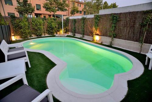 a small pool with green water in a backyard at Charming Home with Pool and Garden, Just Outside Madrid in Villanueva de la Cañada