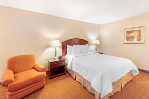 a hotel room with a bed and a chair at Best Western Plus West Covina Inn in West Covina