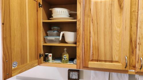 a kitchen cabinet with food items in it at Beargrass Lodging & RV Resort in Hungry Horse