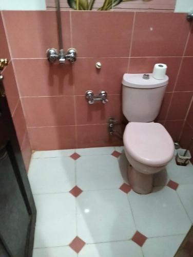 a bathroom with a toilet and a tiled floor at Aswan Nile view house in Aswan