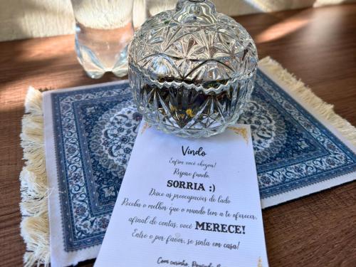 a table with a glass vase on top of a table at Pousada da Baronesa in Nova Petrópolis
