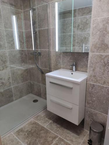 une salle de bain avec un lavabo blanc et une douche dans l'établissement Duplex 6 pers 200m plage centre ville, à Sainte-Maxime