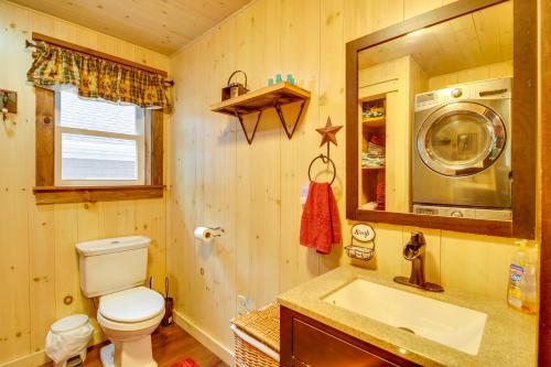 a bathroom with a toilet and a sink and a microwave at The Locke-ness Pond Cabin in Chesterville! in Wilton