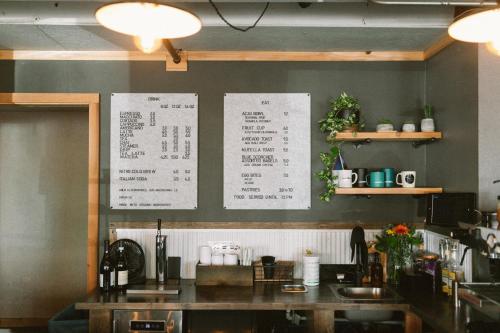 a kitchen with a table and a menu on the wall at Adrift Hotel in Long Beach