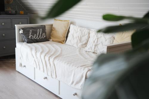 a white couch with pillows on it in a room at Szőlőhegy Vendégház Sümeg in Sümeg