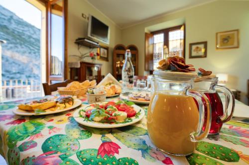 a table with plates of food and a jar of honey at Il Belvedere in Civita