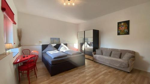 a living room with a couch and a table at Ferienwohnung Freund & Berndt in Nermsdorf