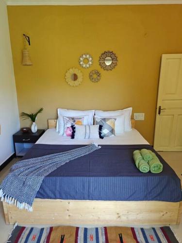 a bedroom with a large bed with pillows on it at SOLS Backyard in Arambol