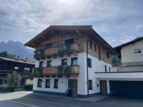 a building with wooden balconies on the side of it at Haus Lackner in Waidring