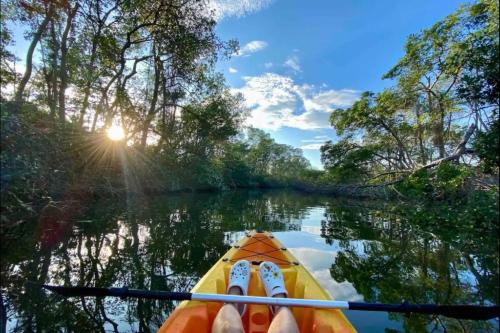 a pair of feet in a kayak on a river at New and modern apartment Belice in Belize City