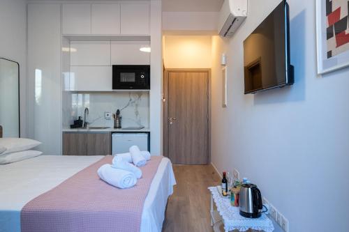 a hotel room with a bed with towels on it at Le Voyageur By the Sea - Furnished Rooms in Larnaka