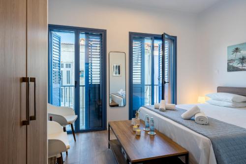 a hotel room with a bed and a table at Le Voyageur By the Sea - Furnished Rooms in Larnaka