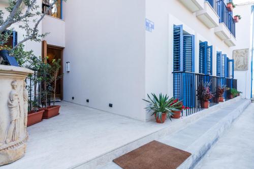 a courtyard of a building with potted plants at Le Voyageur By the Sea - Furnished Rooms in Larnaka