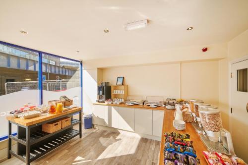 a kitchen with white cabinets and a counter top at Discovery Inn - Leeds in Leeds