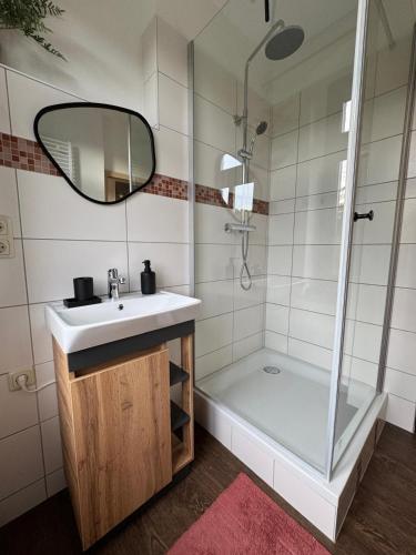 a bathroom with a sink and a shower at Ferienwohnung Uranus 1A in Annaberg-Buchholz