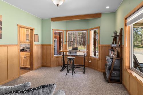 a home office with a desk and windows at Forest Escape in Cle Elum