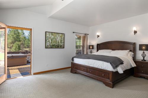 a bedroom with a bed and a sliding glass door at Forest Escape in Cle Elum