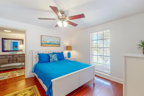a bedroom with a bed and a ceiling fan at Marco Island Manor in Marco Island