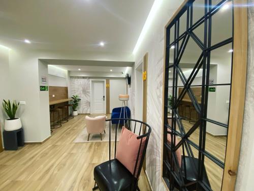 an office corridor with a chair and a desk at Nebula Apartments in Tirana