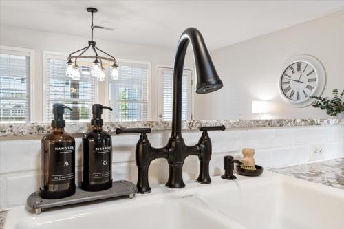 a kitchen sink with a black kitchen faucet at Beautiful 3 bed 2 bath home near Crystal Bridges in Bentonville