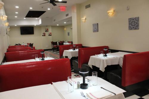 a dining room with tables and red chairs at Holiday Inn Lower East Side by IHG in New York