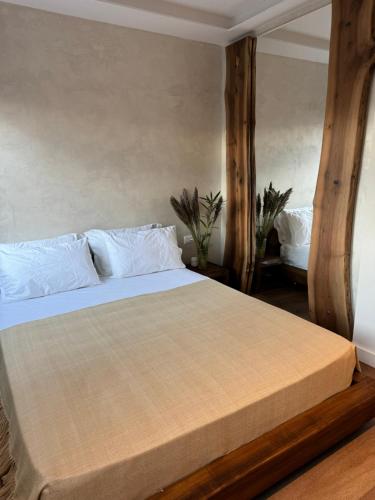 a bedroom with a large bed with white sheets at R&DLux in Durrës