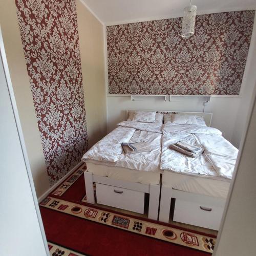 a small bedroom with a bed with two drawers at Gavriel Boutique Residence Wellness Spa in Szada