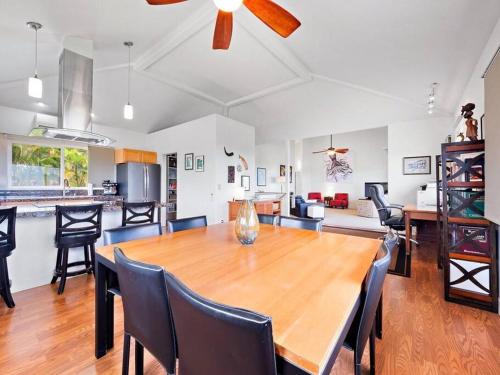 a dining room and kitchen with a wooden table and chairs at Central Oceanview Modern Cozy 3 Bed House in Kailua-Kona