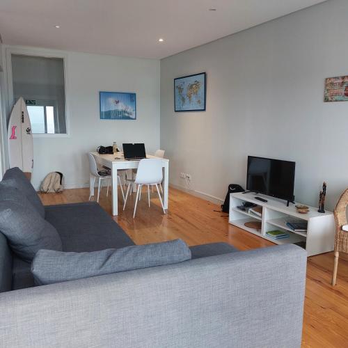 a living room with a couch and a table at SpinBay Apartment in Espinho
