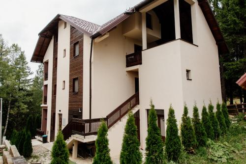 a house with a staircase on the side of it at Apartmani Jela Zlatar in Vukovina