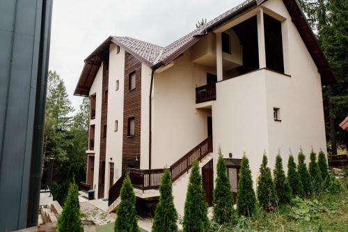 a house in the countryside with trees in the foreground at Apartmani Jela Zlatar in Vukovina