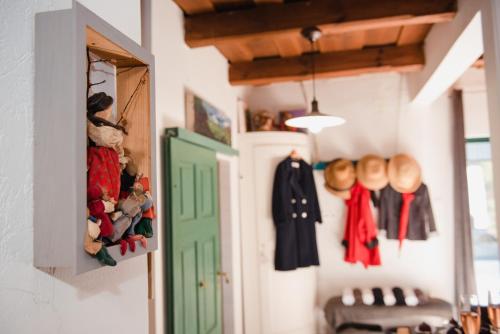 a hallway with a green door and clothes at Wine Cellar Turned Idyllic Spa Escape in Lenti