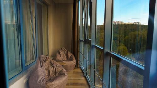 a room with two bean bags in a room with windows at Coliseum Studio C in Chişinău