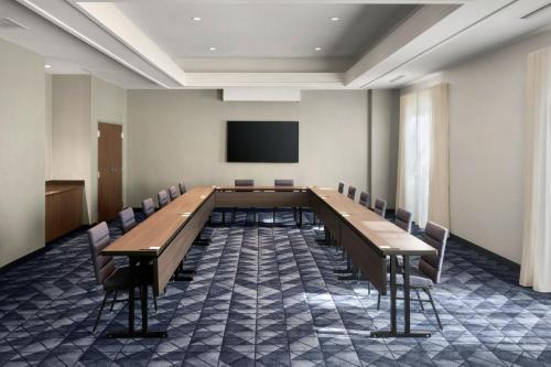a large conference room with a long table and chairs at Courtyard by Marriott New Orleans Metairie in Metairie