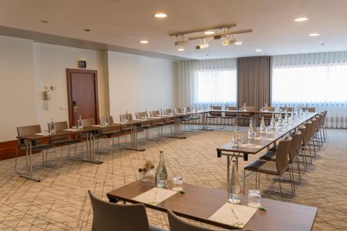 a large room with rows of tables and chairs at Holiday Inn Porto Gaia by IHG in Vila Nova de Gaia