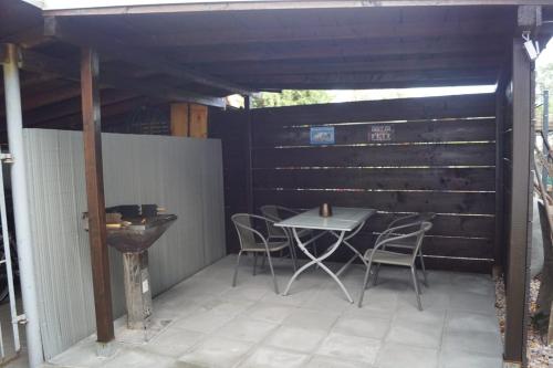 a patio with a table and chairs on it at FEWO Thüringer Becken in Sömmerda