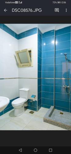 a bathroom with a toilet and a glass shower at FOX SAHEL AQUA RESORT ELGOUNa& Kite in Hurghada