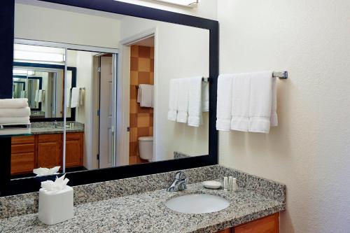 a bathroom with a sink and a large mirror at Residence Inn by Marriott Bloomington by Mall of America in Bloomington