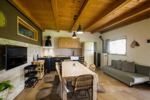 a kitchen and living room with a table and a couch at Casale Bavi in Ortona