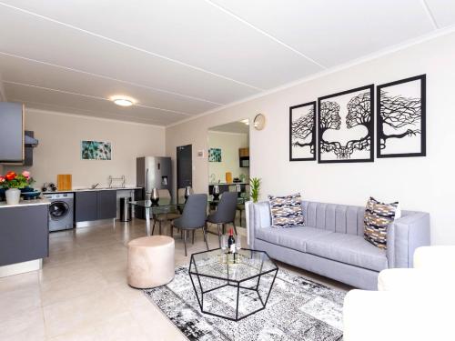 a living room with a couch and a table at Glen Haven in Midrand