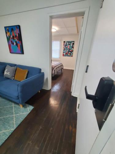 a living room with a blue couch in a room at Parking Netflix Near Airport in Thunder Bay